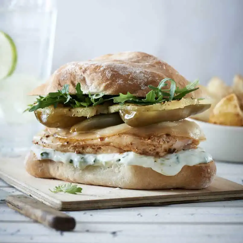 Chicken Burger with Mayonnaise Red Onion Grilled Pineapple and PEPPADEW® Jalapeno Halves and Rocket